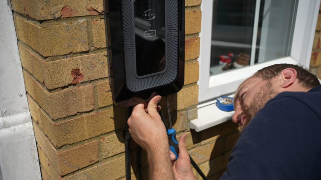 Installer fitting an EV charger