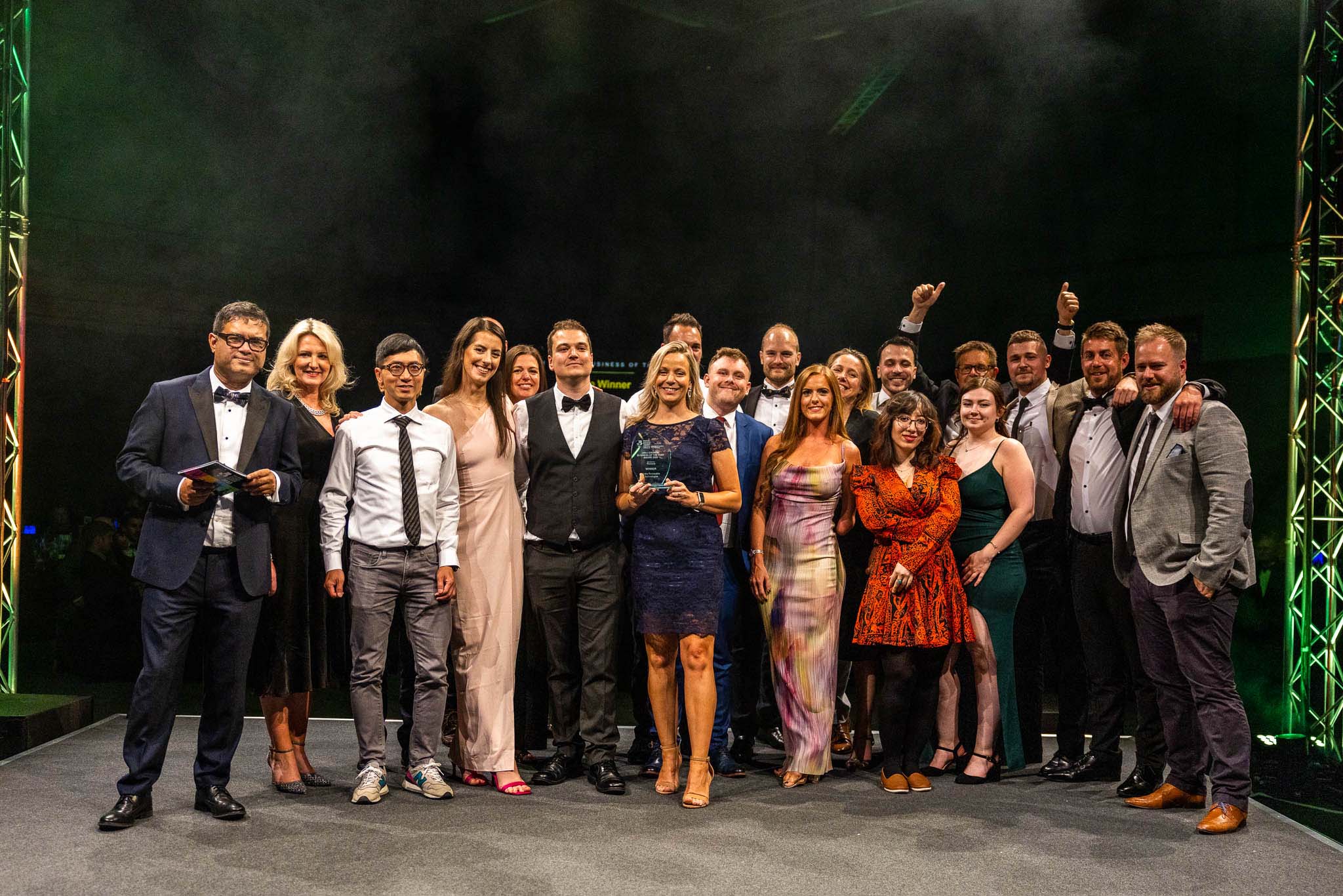 A group of people with an award smiling at the camera
