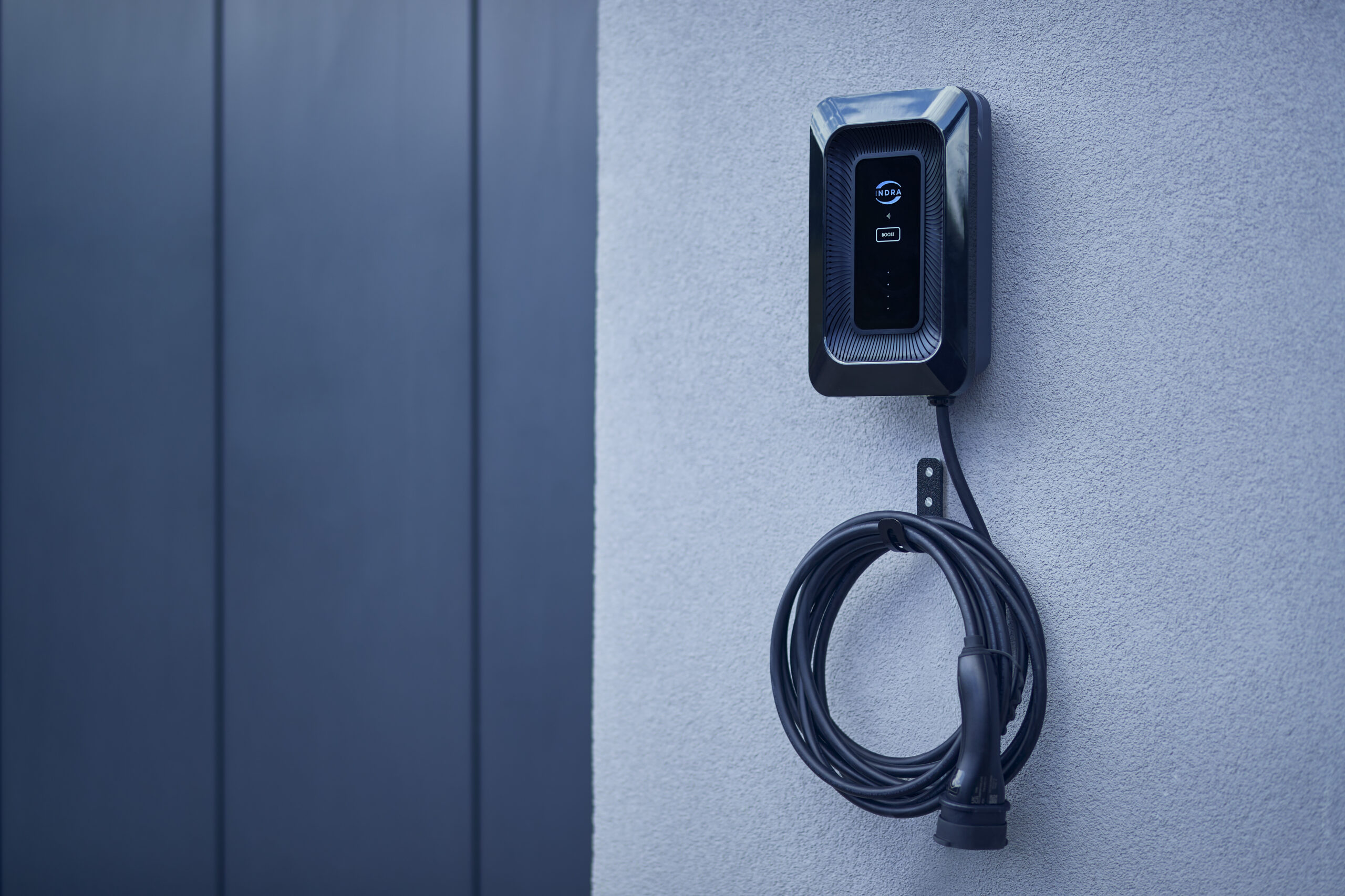 An Indra Smart LUX with a cable coiled hanging on the hook below.