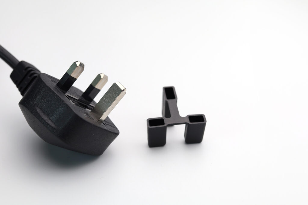 A 3-pin plug and it's plastic cover