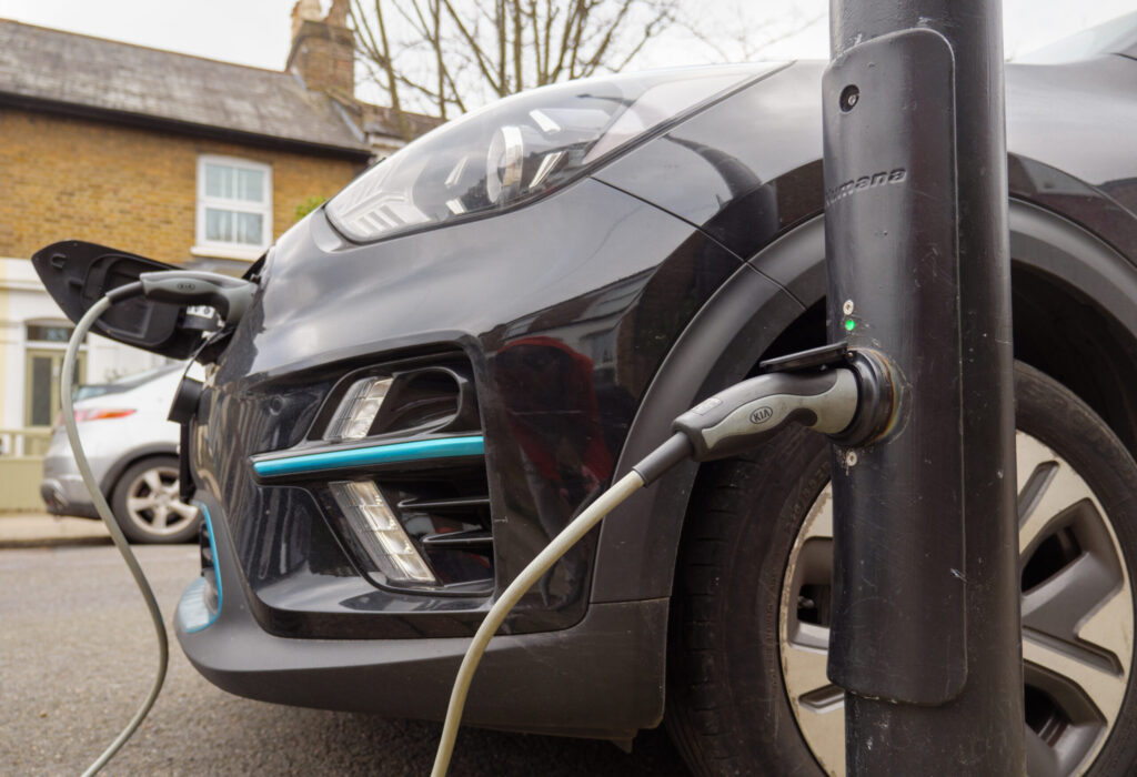 Electric car plugged in to an on-street EV charging lamppost