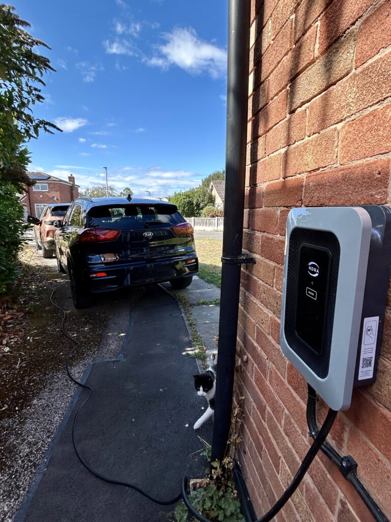 A black Kia e-Niro plugged into an Indra Smart LUX