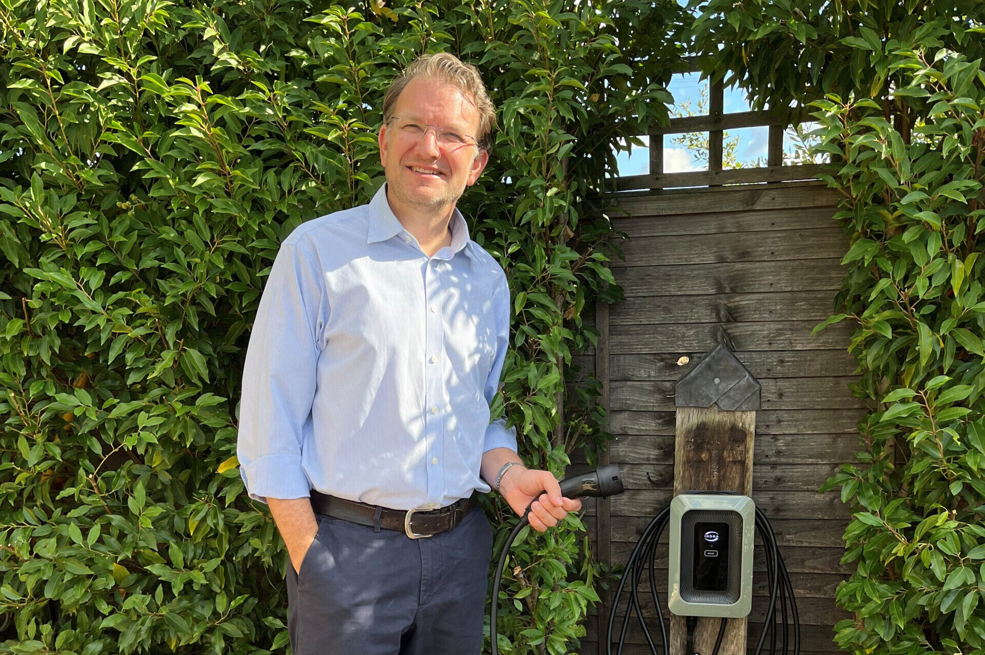 Man holding the plug attached to Indra Smart LUX