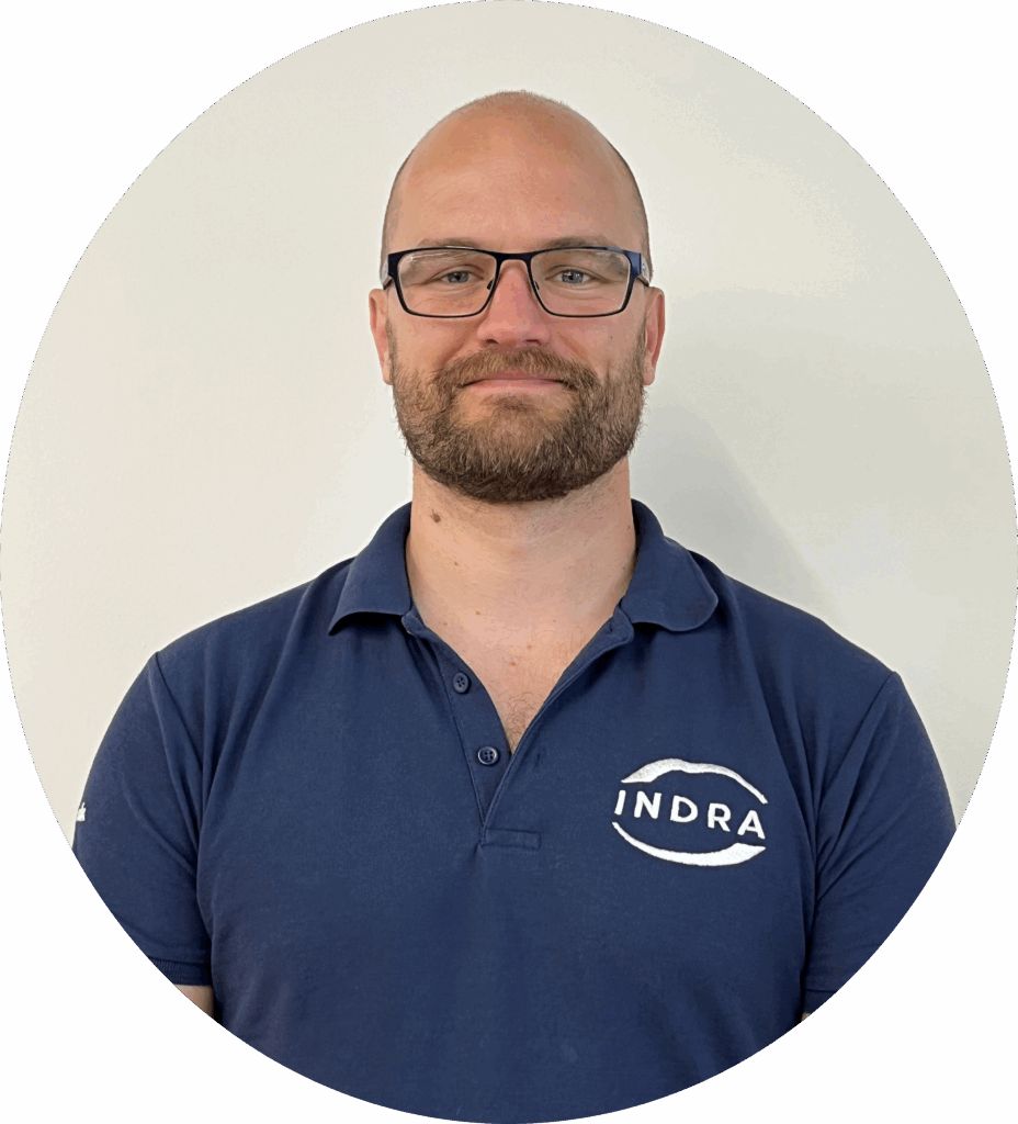 Man in navy Indra logo T-shirt, head and shoulders image