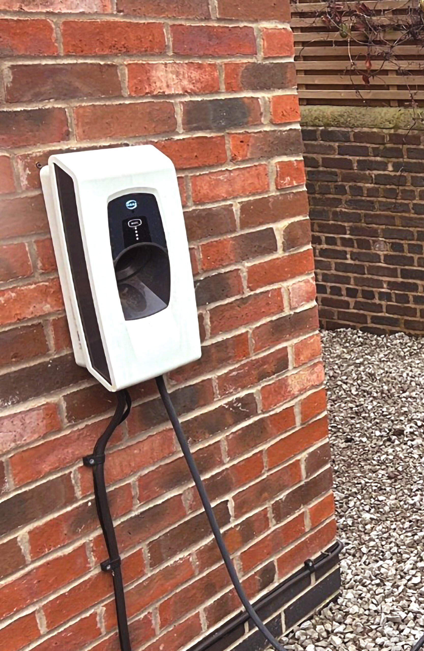Indra Smart PRO EV charger on a brick wall